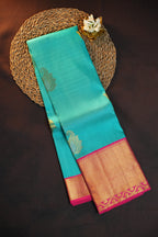 Turquoise Kanchi Pattu Saree with Pink Zari Border