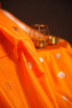 Orange Maharani Pattu Saree with Silver Peacock Motifs